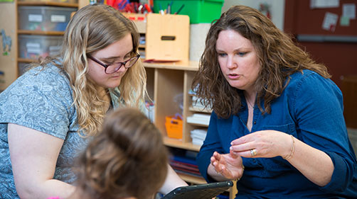 A teacher and a coach working together A teacher and a coach working together